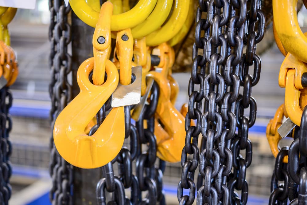 Black steel chain and yellow cargo hooks.