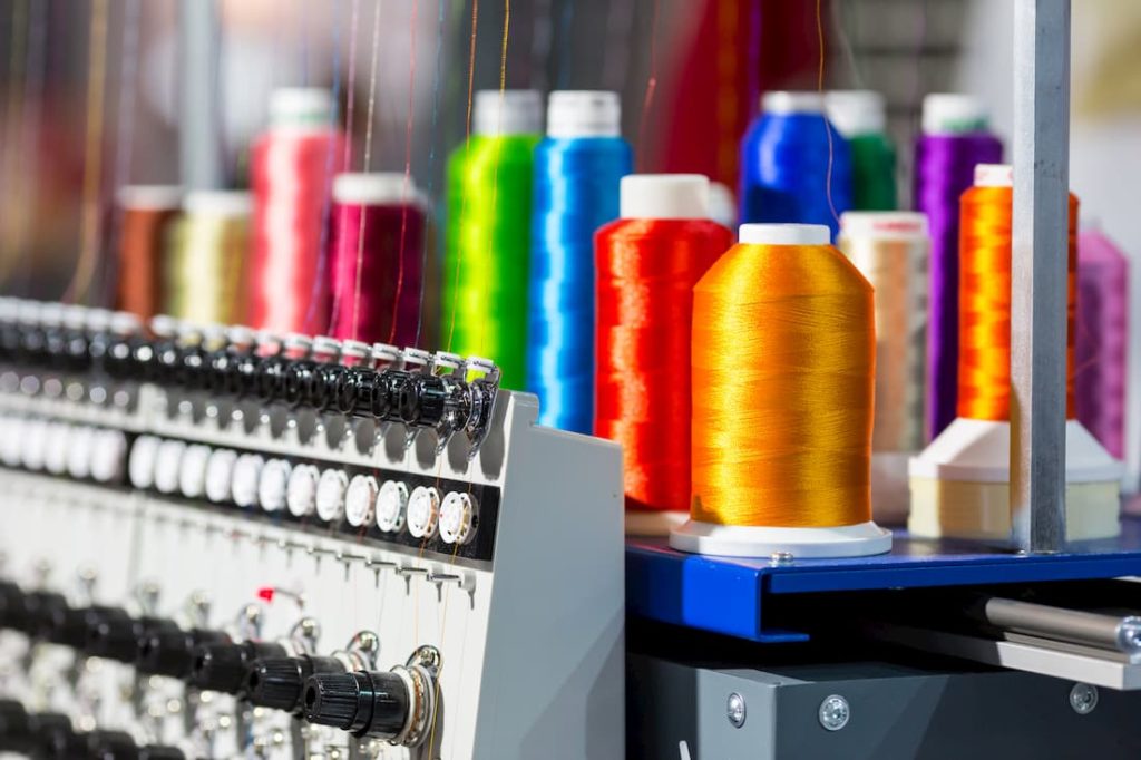 embroidery machine with spools of different coloured thread