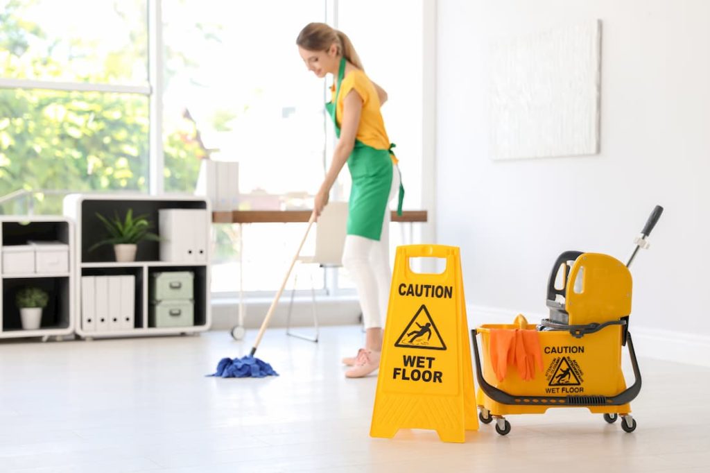 janitor supplies cleaner working mopping floor of commercial space