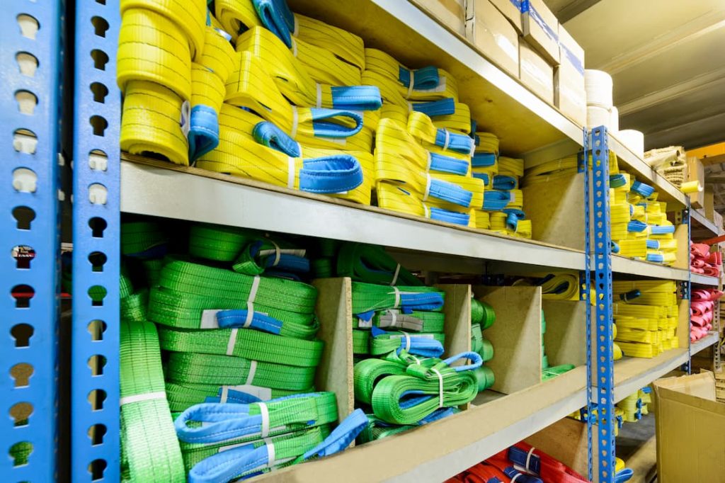 warehouse shelves with rows of lifting equipment