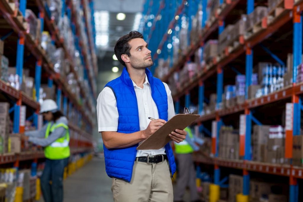 warehouse manager keeping stock of shelf items