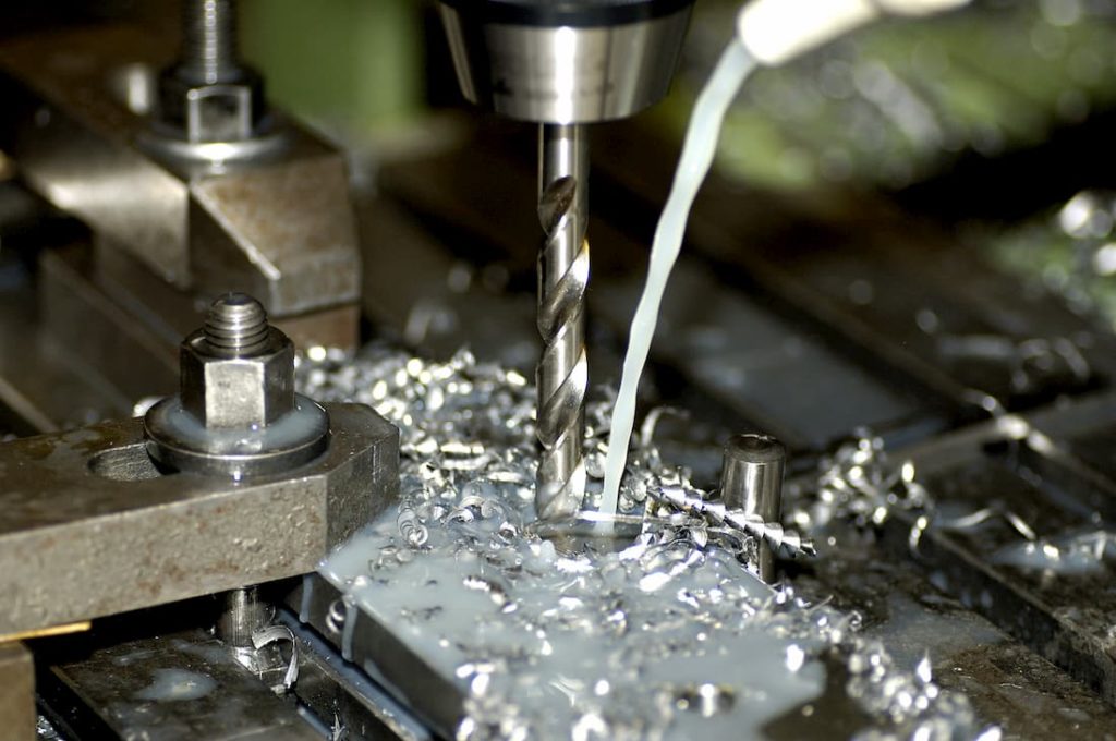 precision cutting taking place using drill bit with lubricant applied