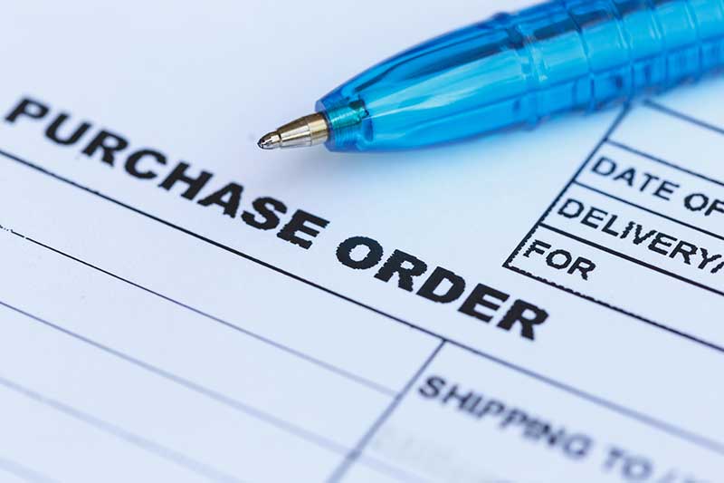 purchase order with blue pen in the office